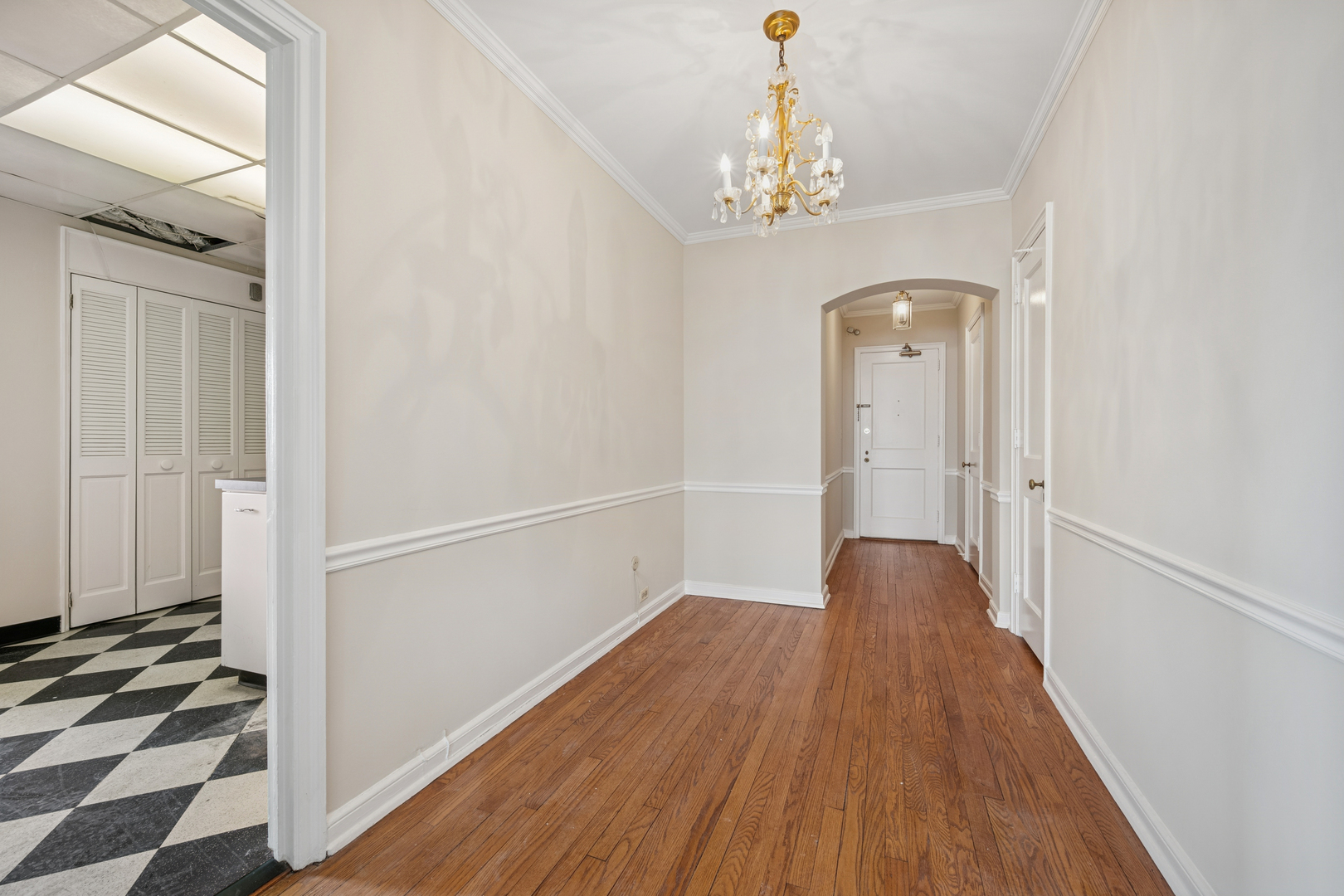 5555 North Sheridan Road, Unit 602 Chicago, IL 60640 - Photo 2 of 20 a view of a hallway with wooden floor and staircase