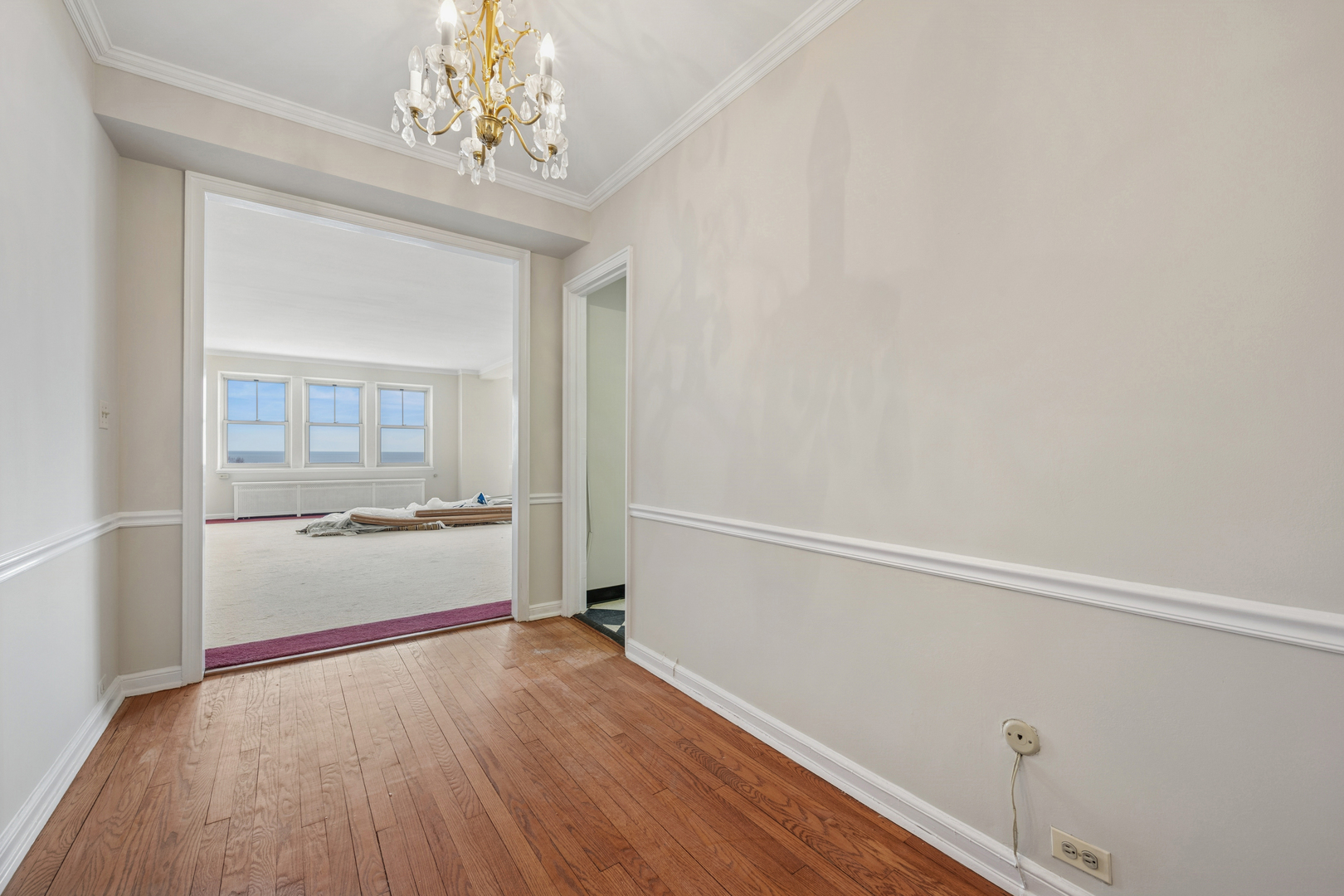 5555 North Sheridan Road, Unit 602 Chicago, IL 60640 - Photo 3 of 20 wooden floor in an empty room with a window