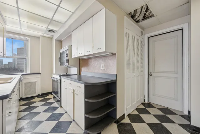 a kitchen with a stove a sink and a refrigerator