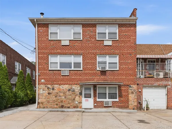 front view of brick house with a yard