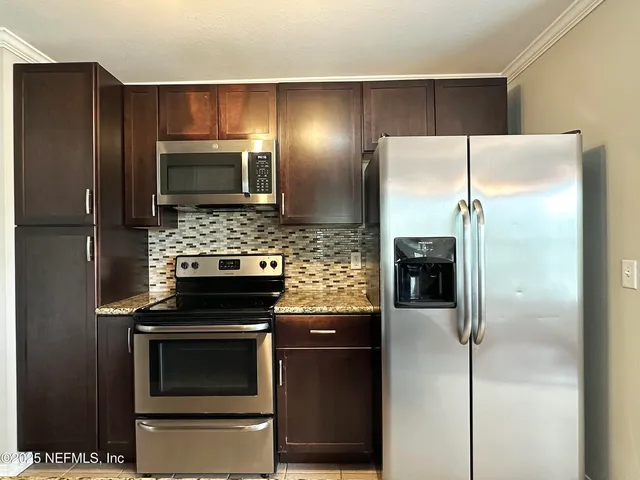 a kitchen with a refrigerator stove and microwave