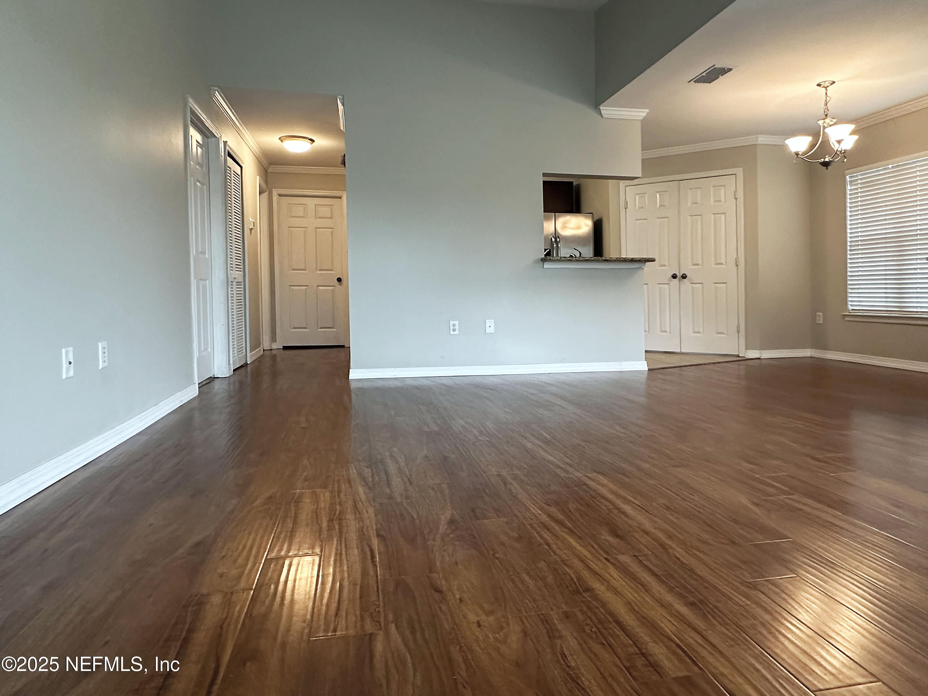 7800 Point Meadows Drive, Unit 631 Jacksonville, FL 32256 - Photo 13 of 26 an empty room with wooden floor and windows
