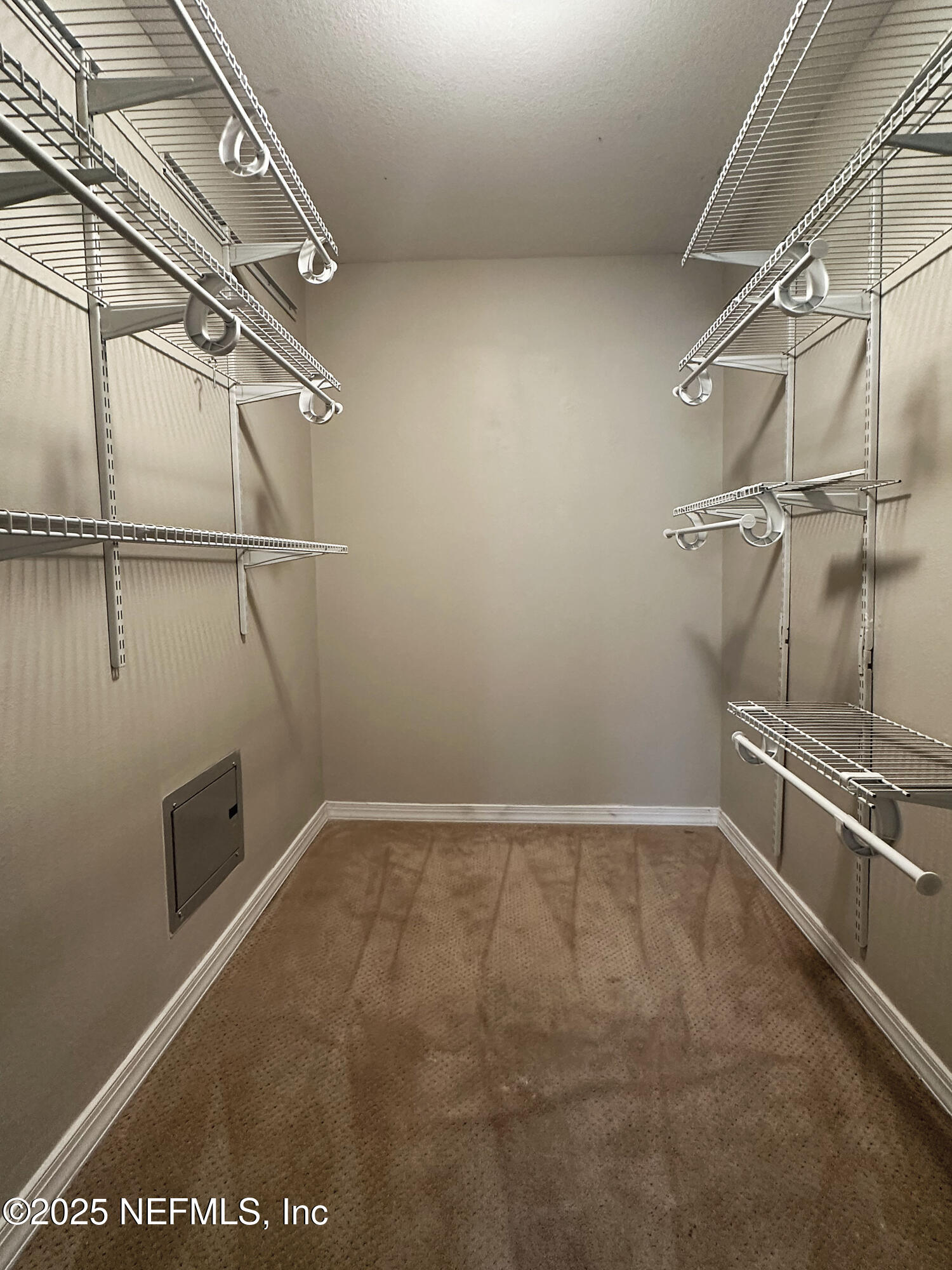 7800 Point Meadows Drive, Unit 631 Jacksonville, FL 32256 - Photo 14 of 26 a view of a room with racks on the wall