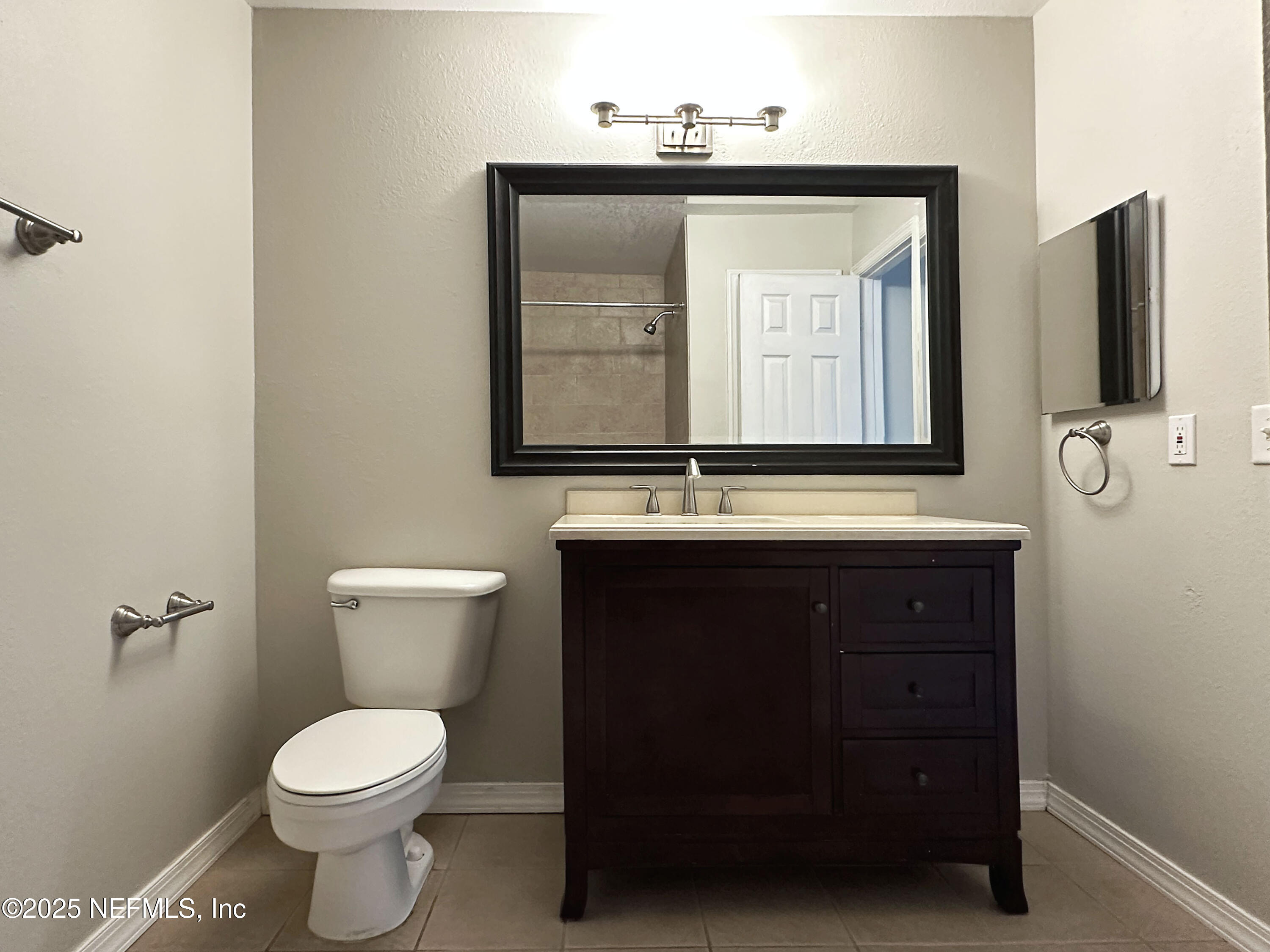 7800 Point Meadows Drive, Unit 631 Jacksonville, FL 32256 - Photo 15 of 26 a bathroom with a toilet sink and mirror