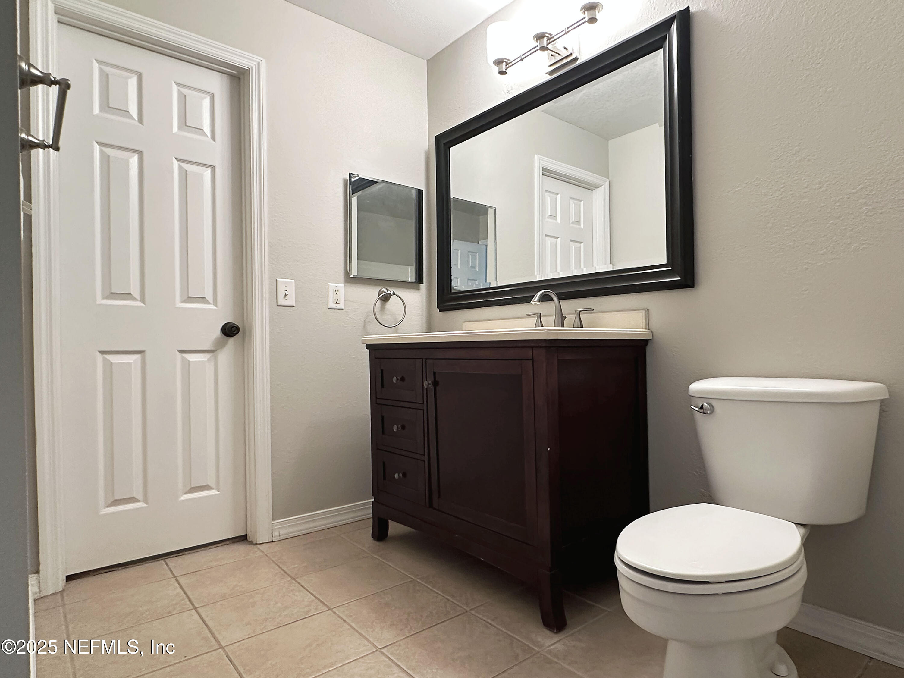 7800 Point Meadows Drive, Unit 631 Jacksonville, FL 32256 - Photo 21 of 26 a bathroom with a toilet sink and mirror