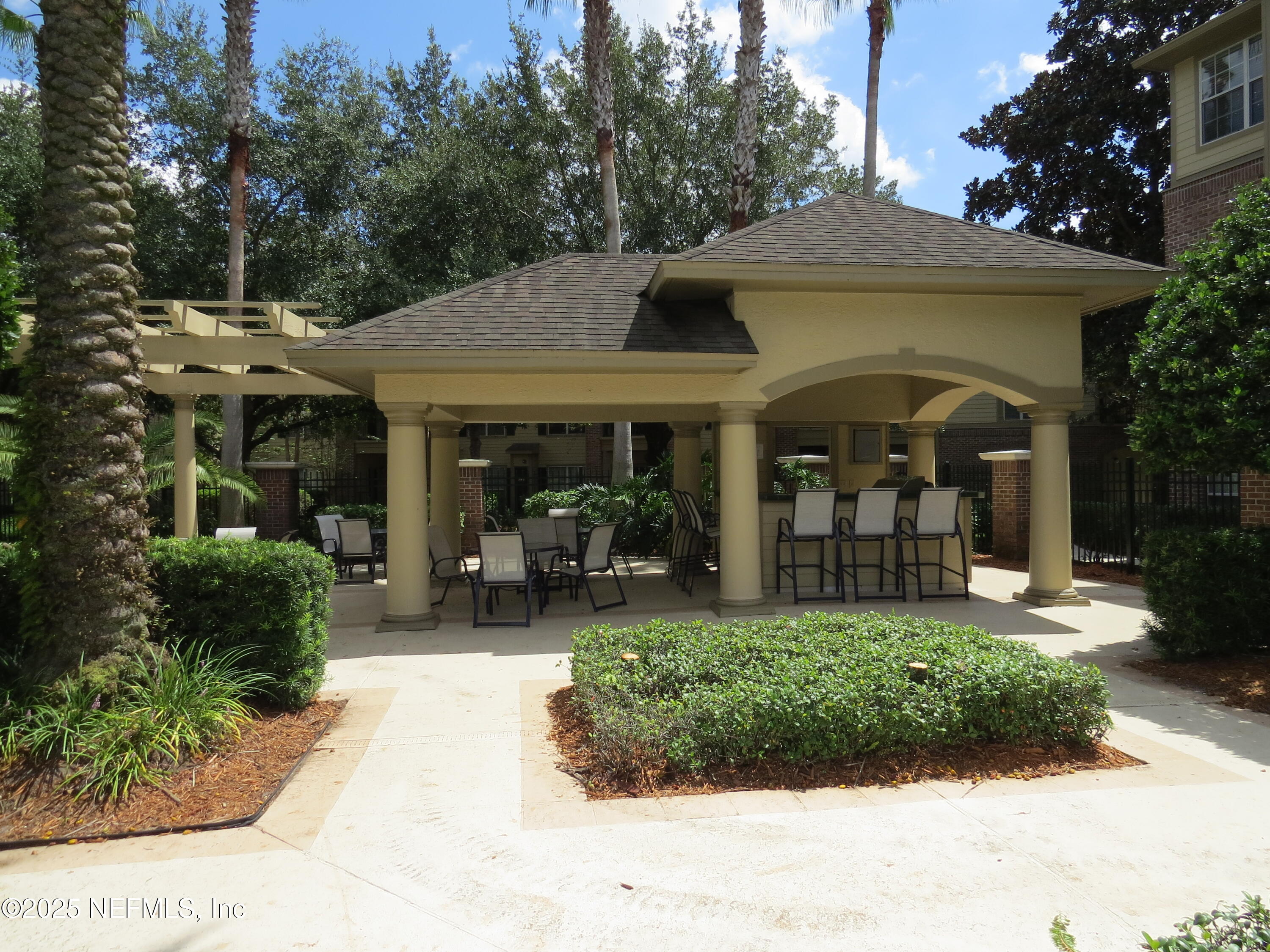 7800 Point Meadows Drive, Unit 631 Jacksonville, FL 32256 - Photo 3 of 26 a front view of a house with a garden