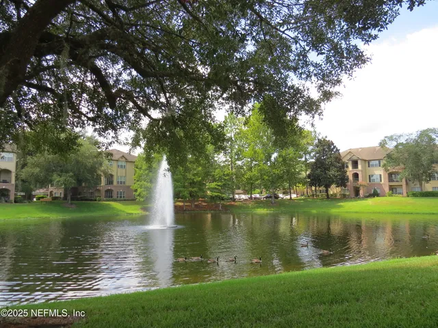 a view of a lake with a house in the background