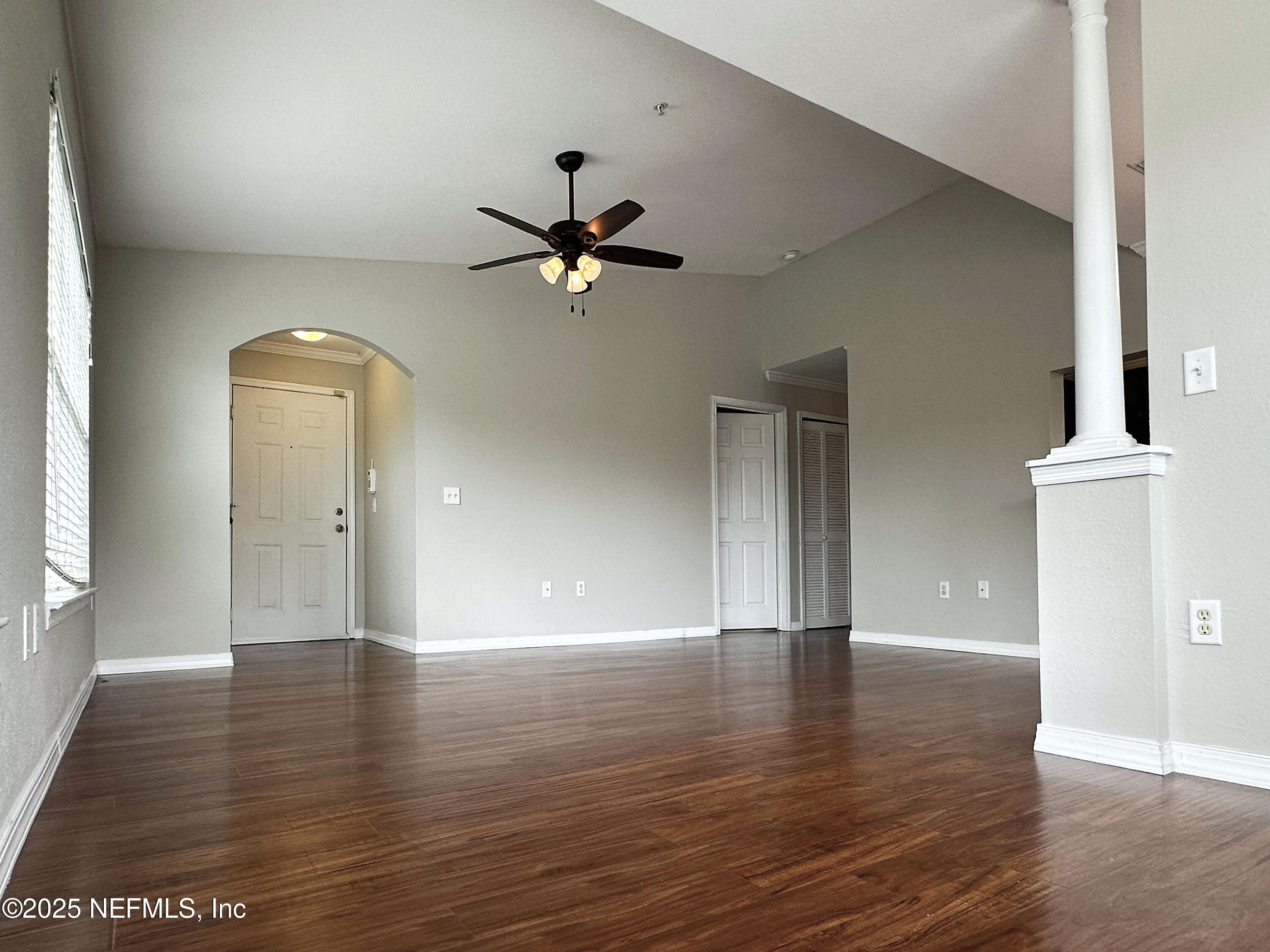 7800 Point Meadows Drive, Unit 631 Jacksonville, FL 32256 - Photo 5 of 26 a view of an empty room with window and wooden floor