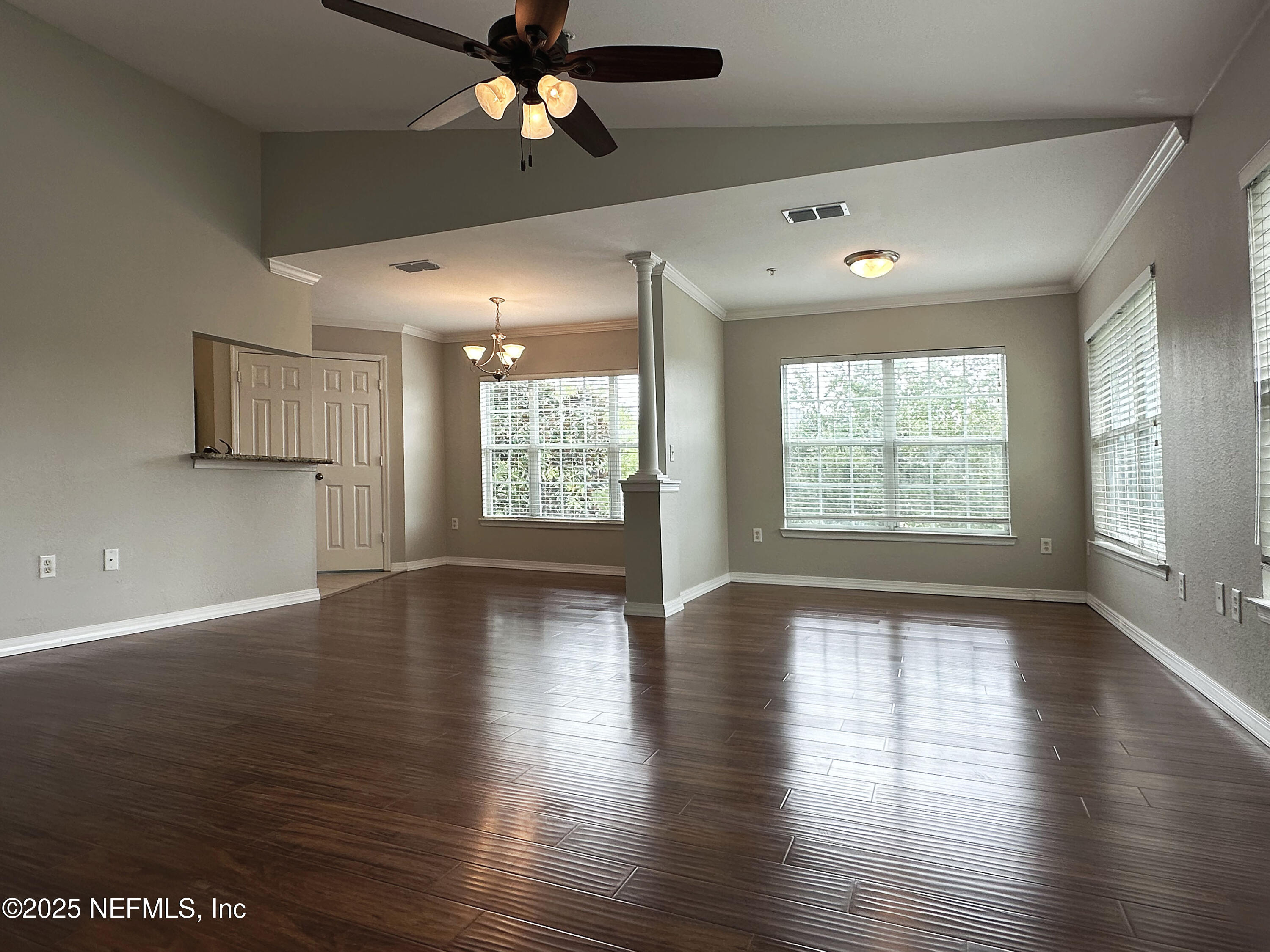 7800 Point Meadows Drive, Unit 631 Jacksonville, FL 32256 - Photo 7 of 26 an empty room with wooden floor and windows