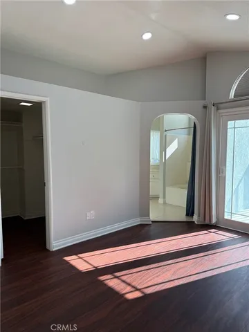 a view of a livingroom with wooden floor and cabinet