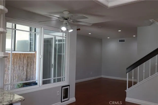 wooden floor in an empty room with a window