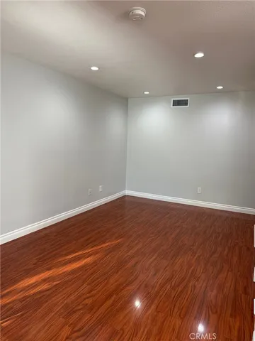 a view of room with wooden floor