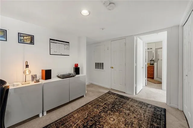 a bathroom with a granite countertop toilet sink and mirror