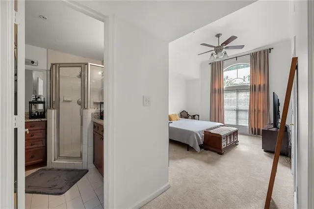 a bathroom with a granite countertop shower sink and mirror
