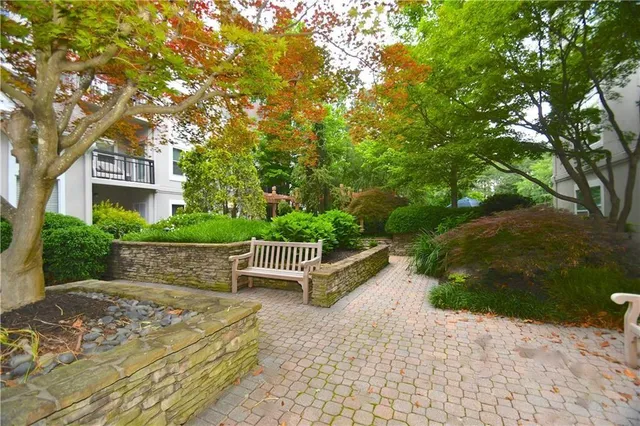 a view of backyard with outdoor seating and trees