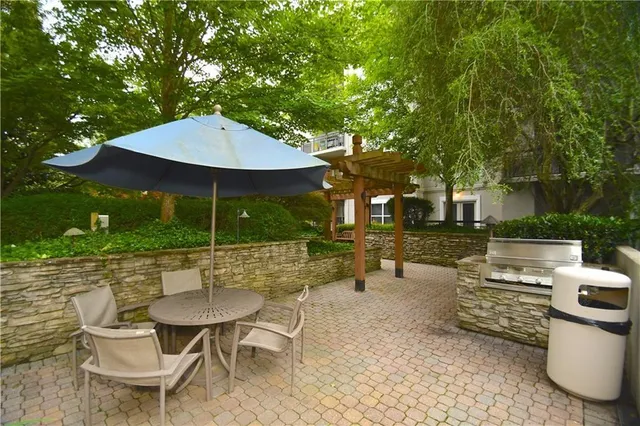 a view of a patio with a table and chairs under an umbrella
