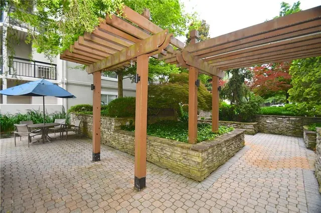 a view of a patio with table and chairs and potted plants