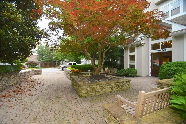 a front view of a house with a yard and fountain