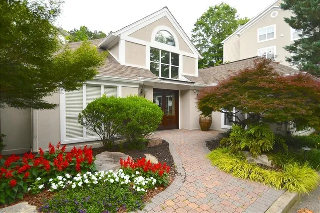 a view of a sign board with flower plants