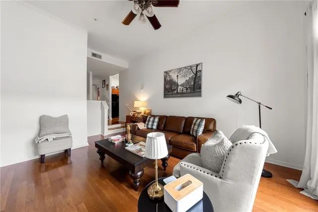 a living room with furniture and a wooden floor