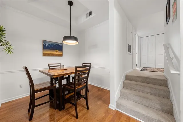 a kitchen with granite countertop a stove top oven a sink dishwasher and cabinets with wooden floor