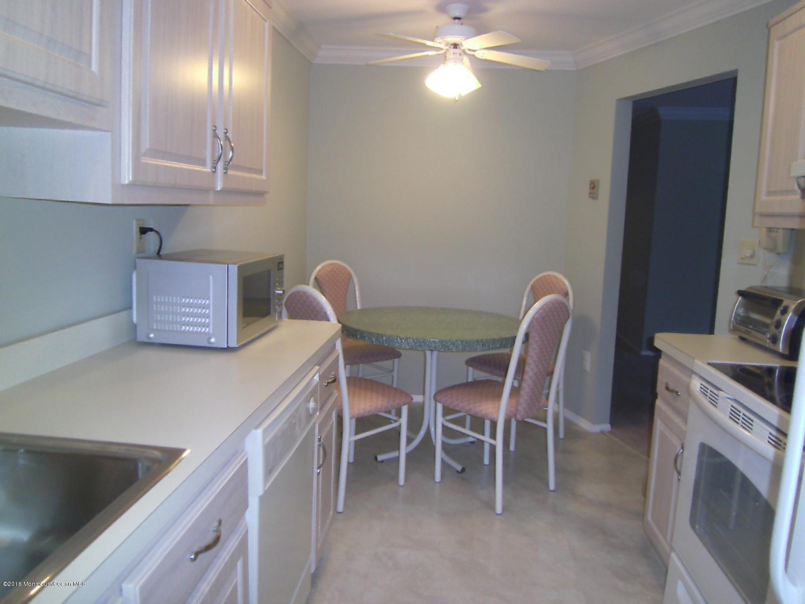 a dining room with furniture and chandelier