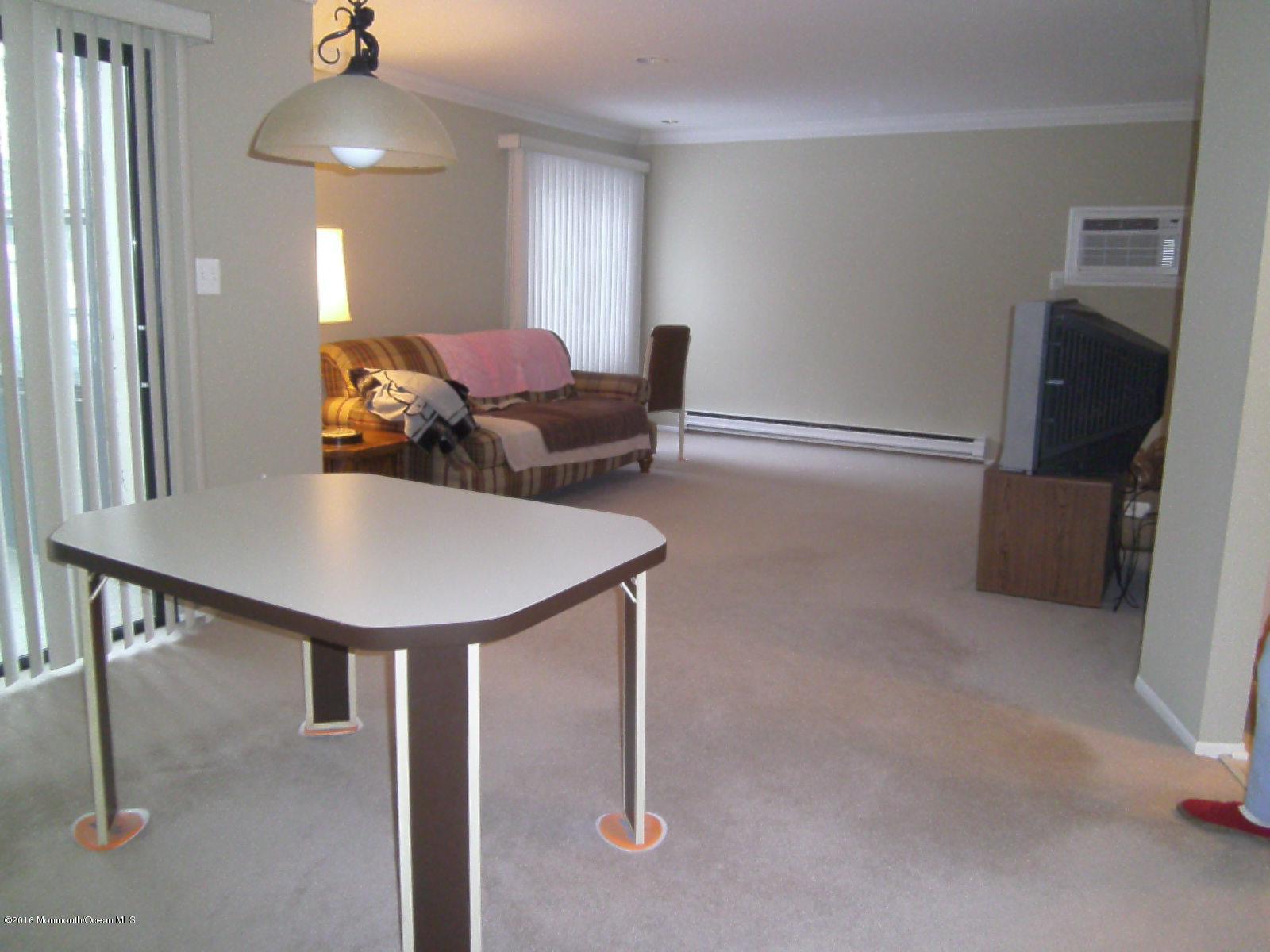 30 Meadow Green Circle, Unit E Manalapan, NJ 07726 - Photo 5 of 11 a view of a livingroom with furniture and a chandelier