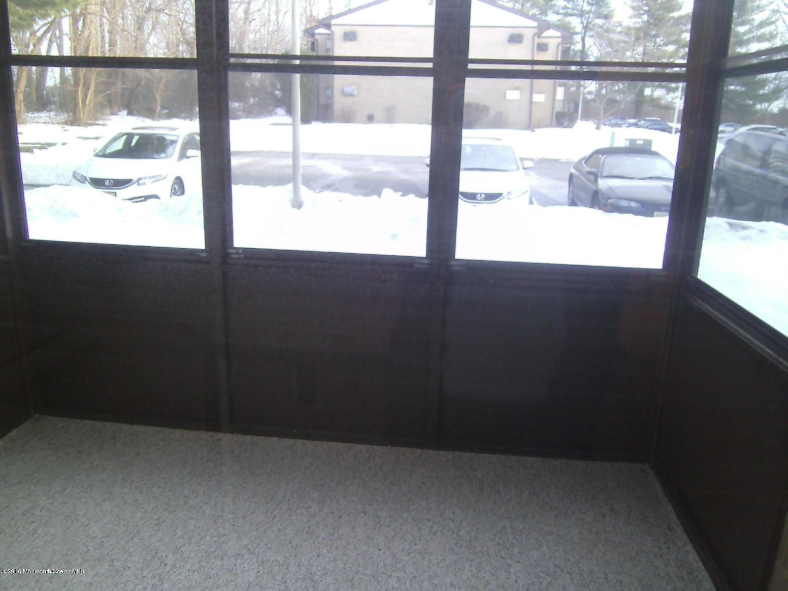 30 Meadow Green Circle, Unit E Manalapan, NJ 07726 - Photo 6 of 11 a view of an empty room with a window