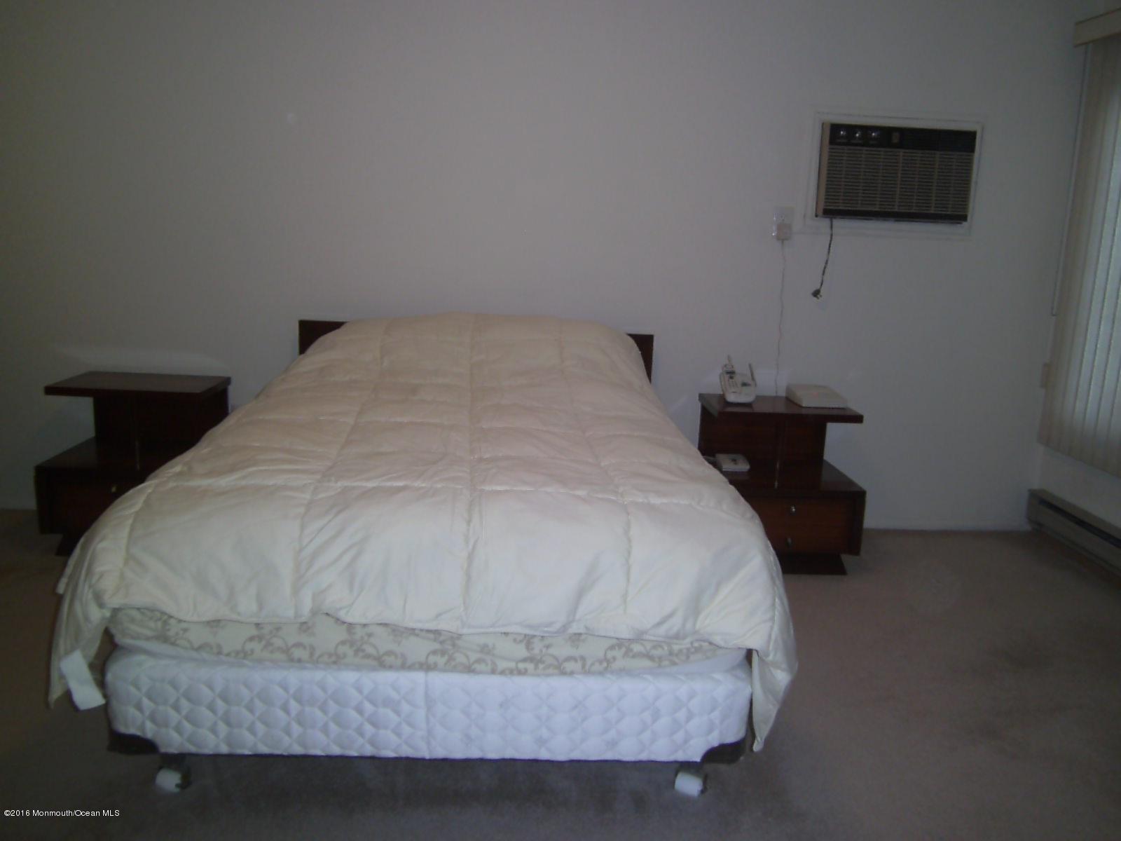 30 Meadow Green Circle, Unit E Manalapan, NJ 07726 - Photo 9 of 11 a bedroom with a bed and tv