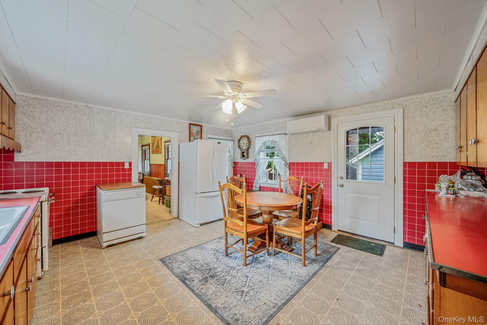 1055 Oregon Road Mattituck, NY 11952 - Photo 6 of 33 Kitchen featuring white appliances, wood cabinetry, tiled backsplash, and patterned floor tile