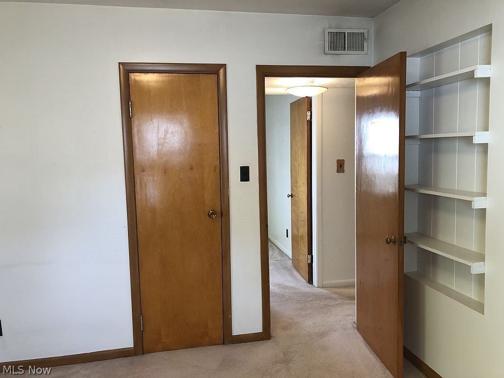 821 Reed Avenue Akron, OH 44306 - Photo 11 of 21 Master bedroom has display shelves and ample closet space. This room has natural wood trim.