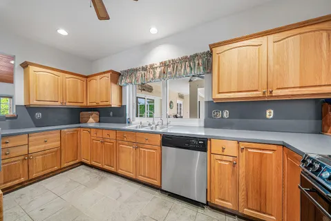 a kitchen with stainless steel appliances granite countertop a refrigerator and a sink