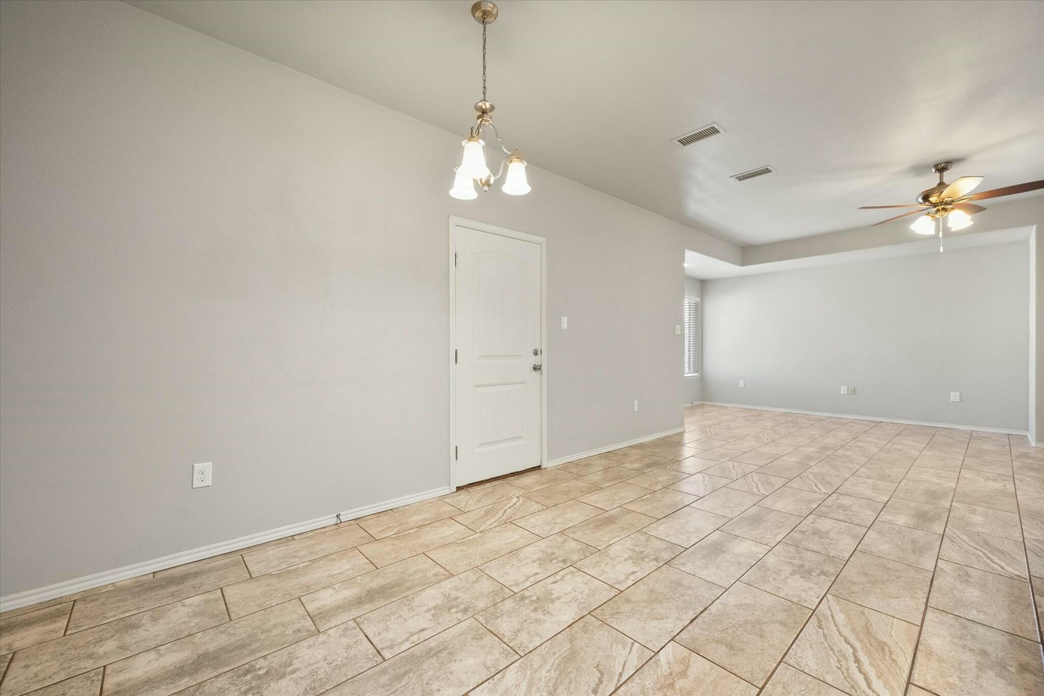 2619 113th Street Lubbock, TX 79423 - Photo 12 of 31 a view of an empty room with a chandelier fan