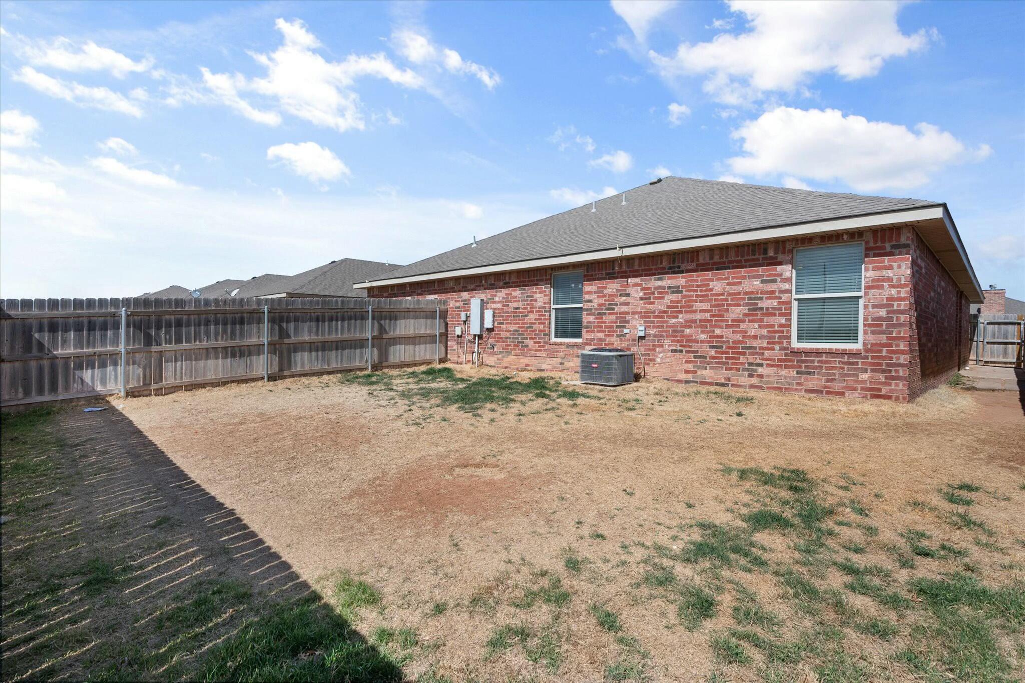 2619 113th Street Lubbock, TX 79423 - Photo 30 of 31 a view of a house with a backyard