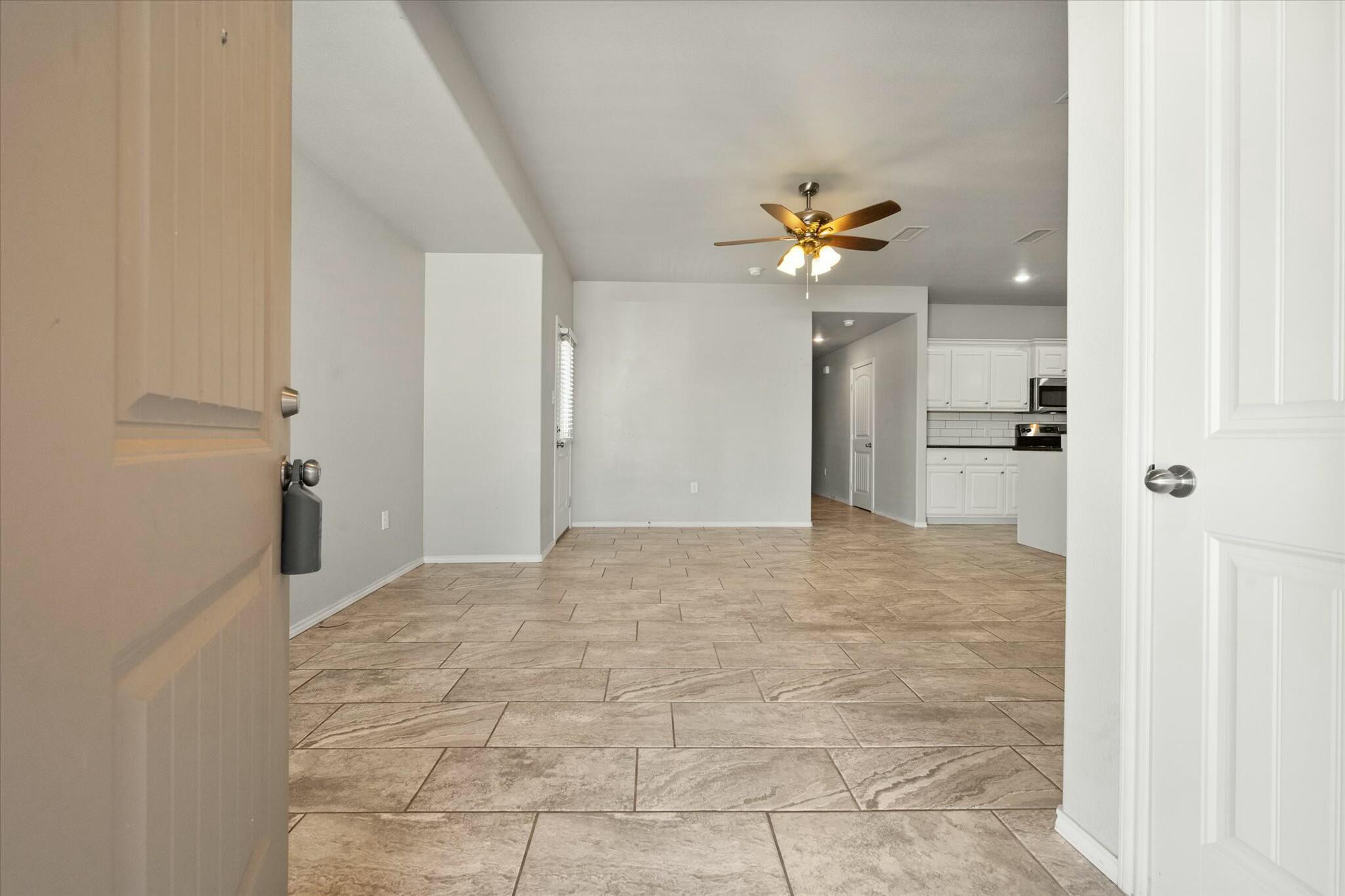 2619 113th Street Lubbock, TX 79423 - Photo 4 of 31 a view of a hallway with a chandelier