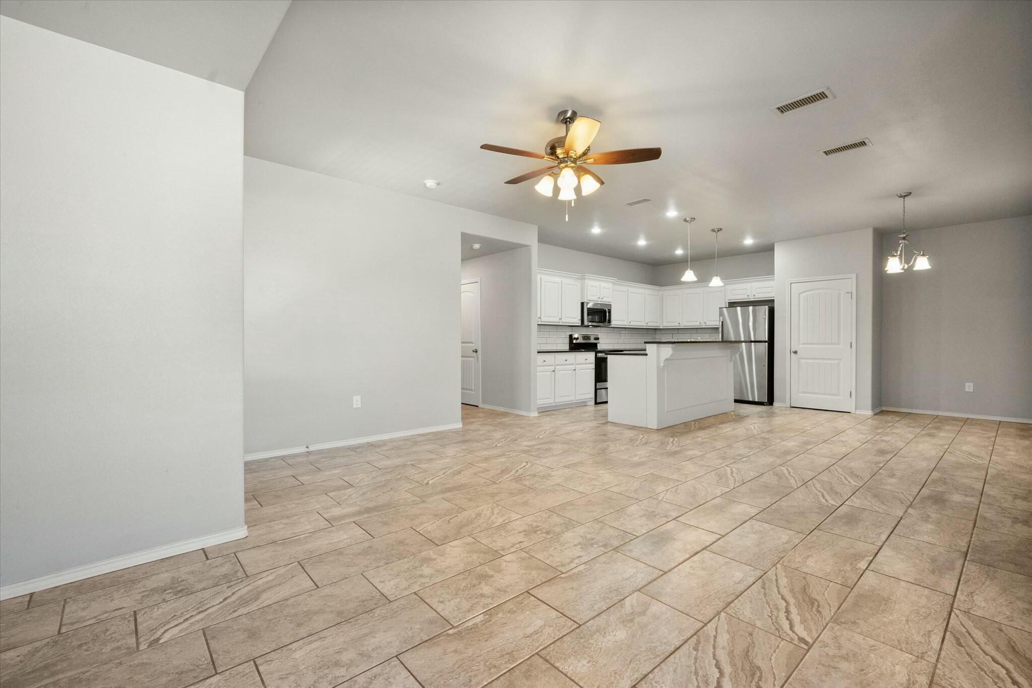 2619 113th Street Lubbock, TX 79423 - Photo 6 of 31 a view of a kitchen with a sink and a refrigerator