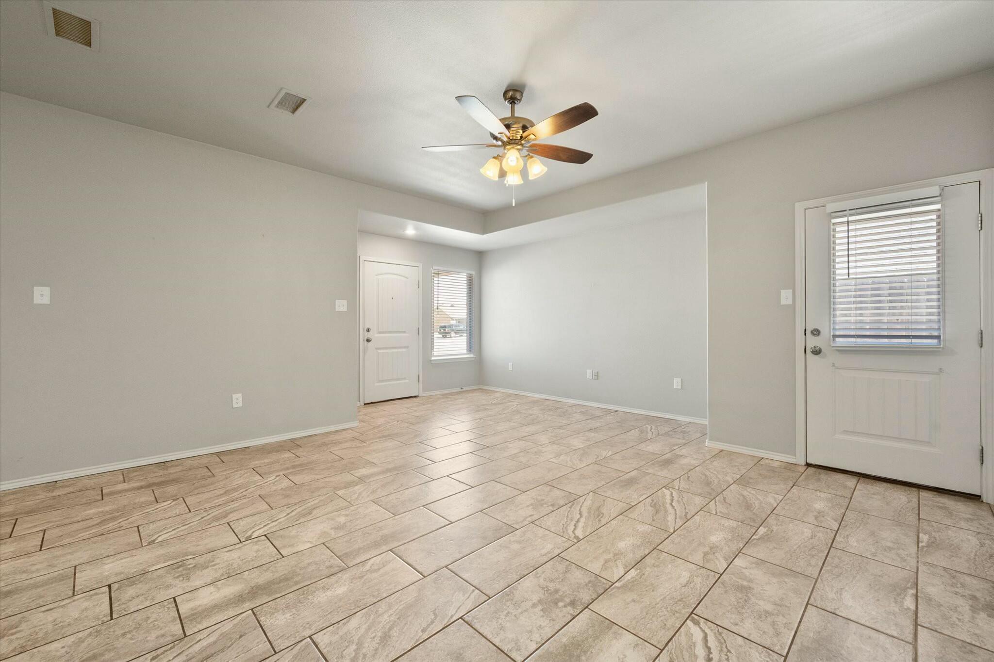 2619 113th Street Lubbock, TX 79423 - Photo 10 of 31 a view of an empty room and chandelier fan