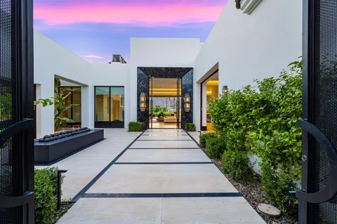a living room with a bed furniture and next to a window