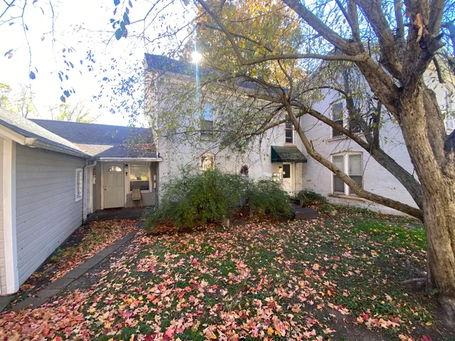 a view of backyard of house with trees