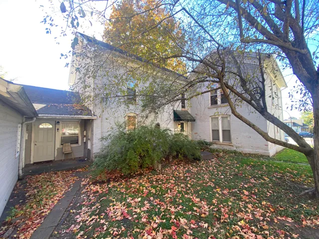 a backyard of a house with large tree