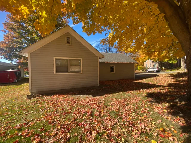a backyard of a house with yard and outdoor seating