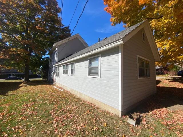 a view of a house with yard and a garage