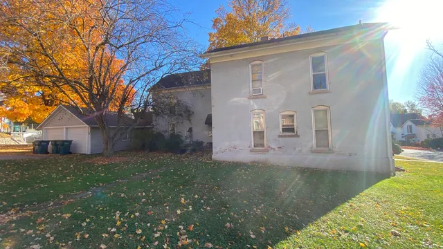 a kitchen with a refrigerator and white cabinets