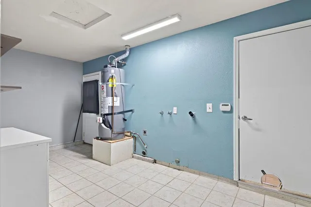 a room with a chair and white walls