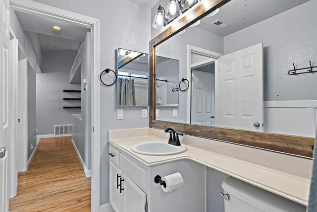 a bathroom with a sink a mirror and a shower