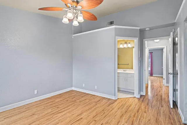 a view of empty room with wooden floor