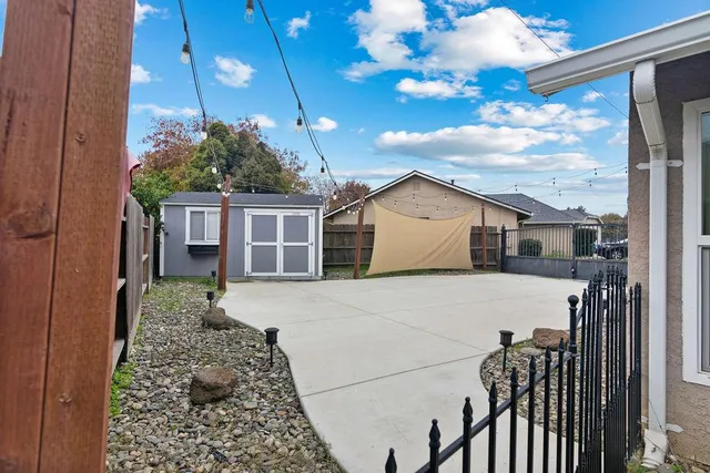 a view of a house with a yard and potted plants