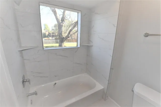 a white bath tub sitting next to a window