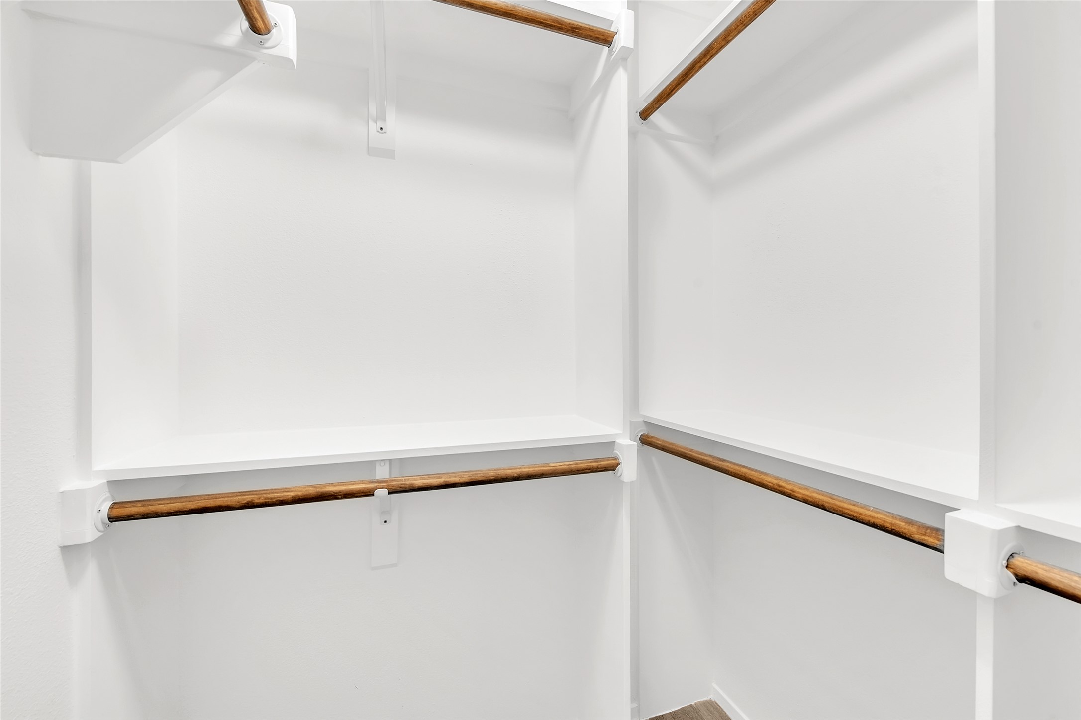 7209 Gunnison Pass Austin, TX 78724 - Photo 10 of 19 Integrated shelving and multiple hanging rods create an orderly and spacious walk-in closet.