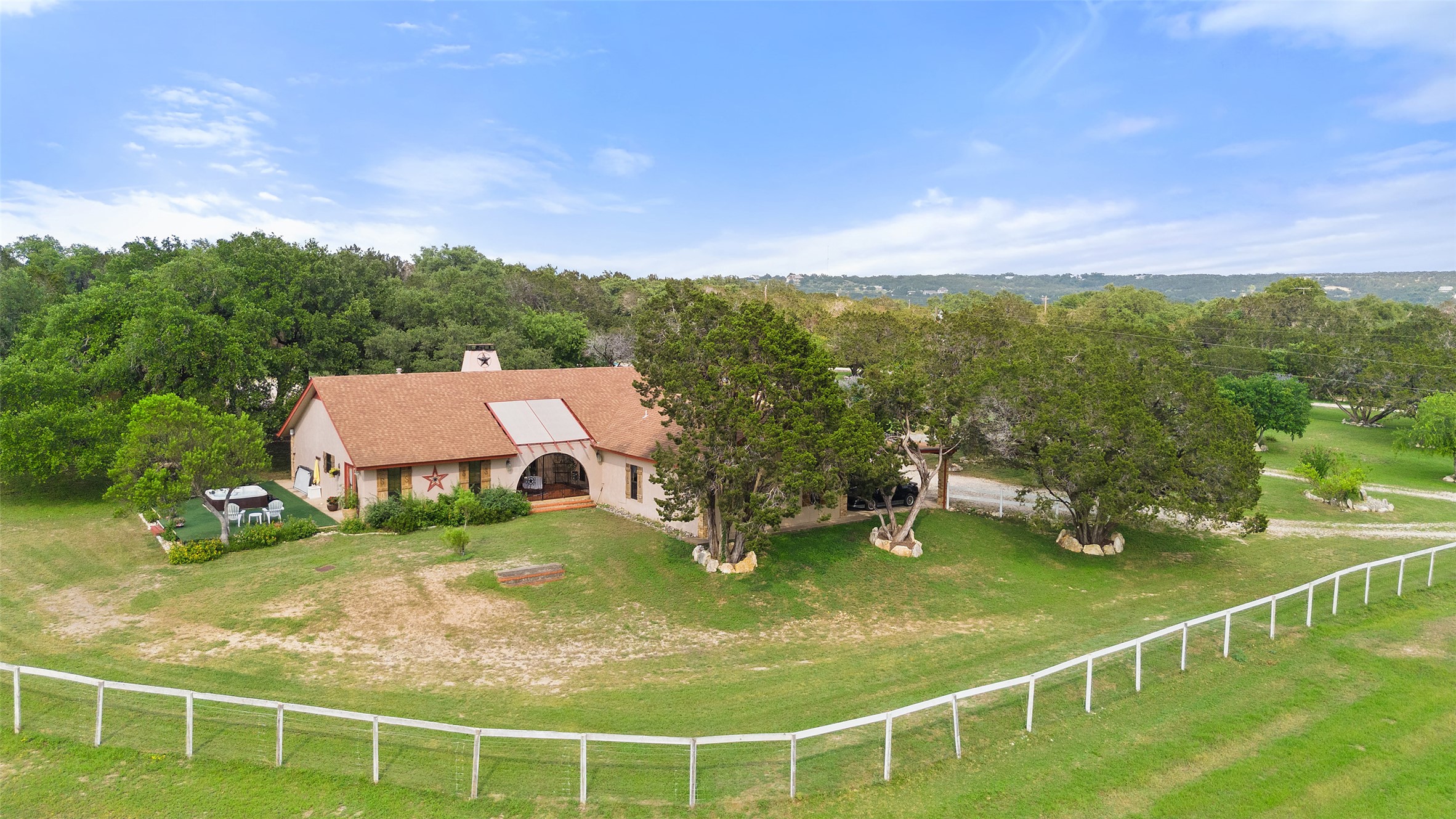 23200 Fulkes Road Leander, TX 78641 - Photo 1 of 15 A sprawling estate nestled among mature trees with a vast, fenced yard.